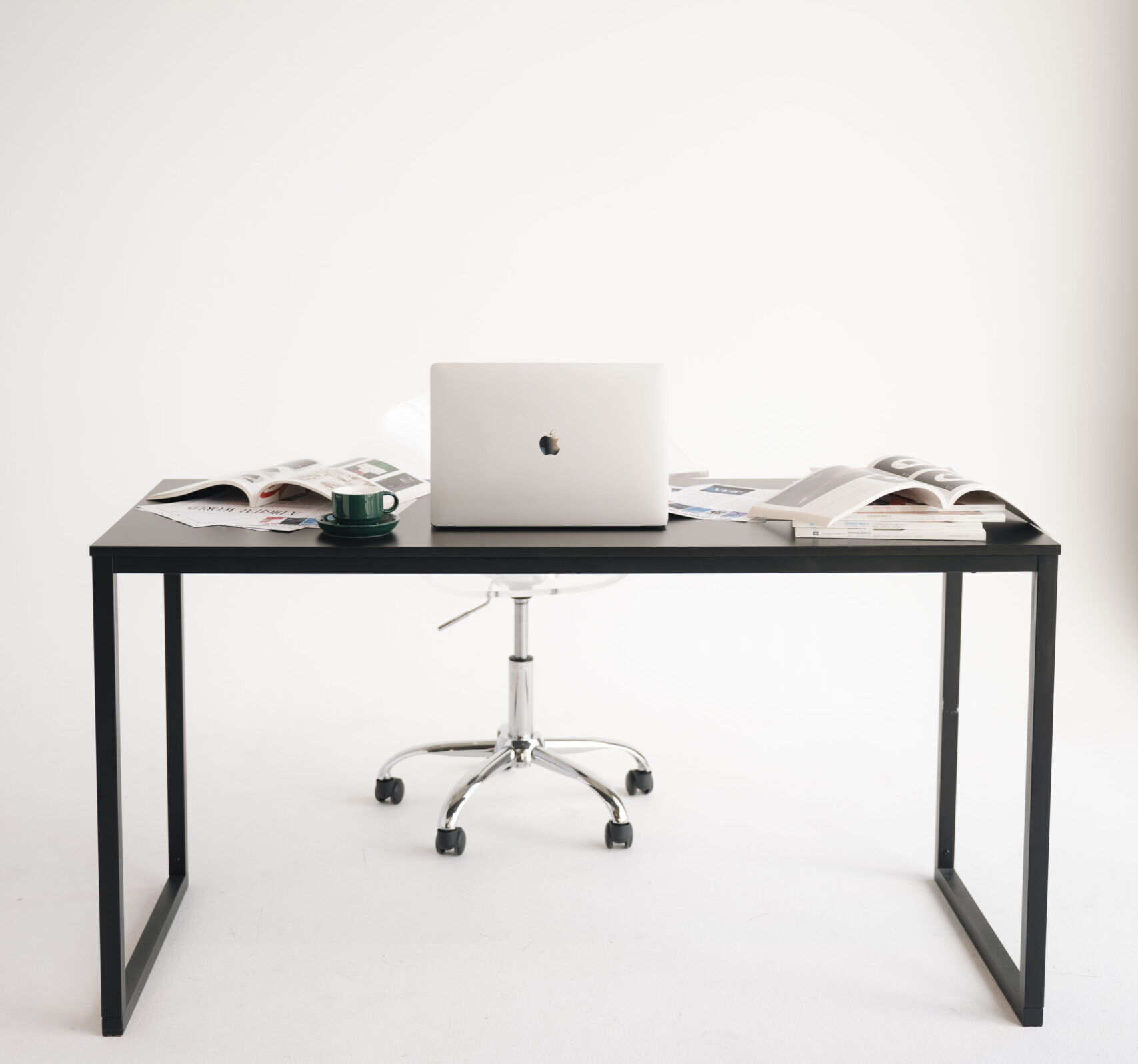 Shot of a desk with a laptop and digital marketing ads strewn about.